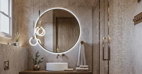 Specchio tondo retroilluminato sopra un lavabo in un bagno in pietra